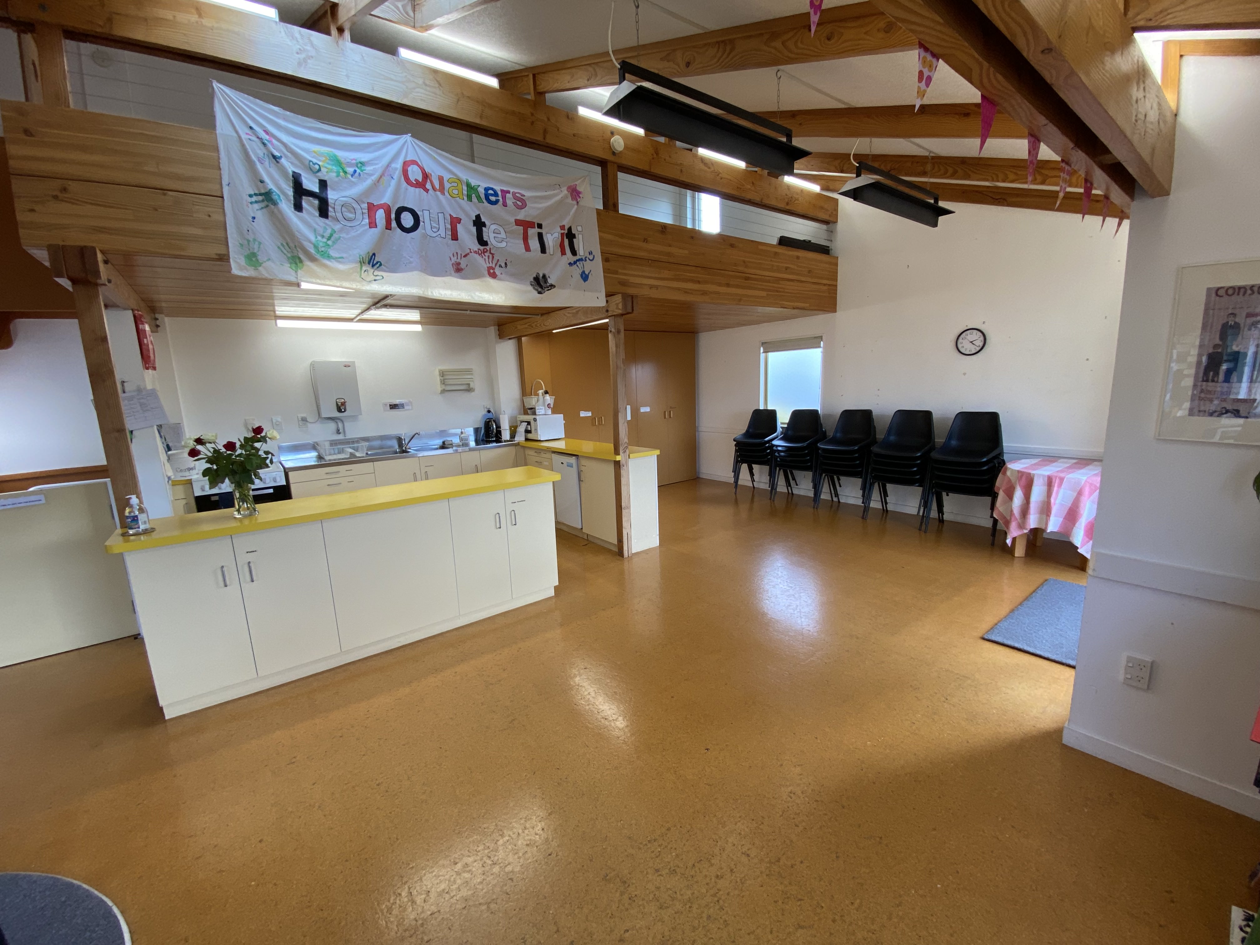 A room with an open plan kitchen on one side