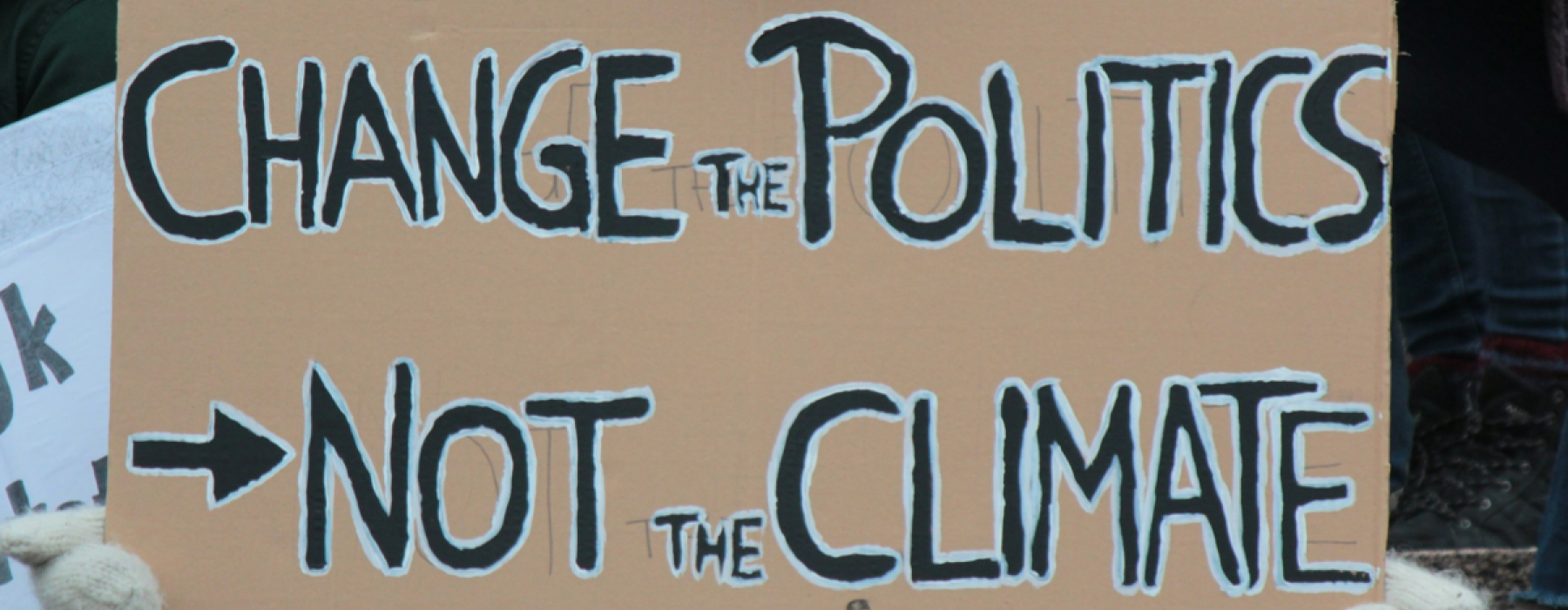 banner with words: change politics not the climate