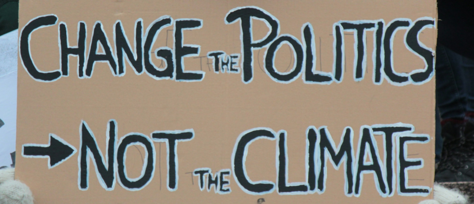 banner with words, Change the politics not the climate