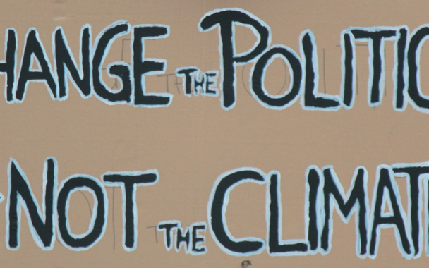 banner with words, Change the politics not the climate